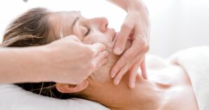 Woman-having-a-relaxing-facial-treatment-at-a-spa